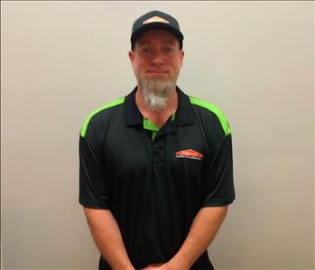 male employee with a beard wearing a SERVPRO hat and shirt