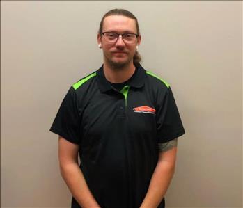 male employee with long hair wearing a SERVPRO shirt