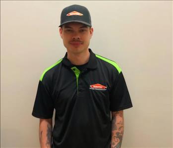 male employee in a SERVPRO shirt and hat