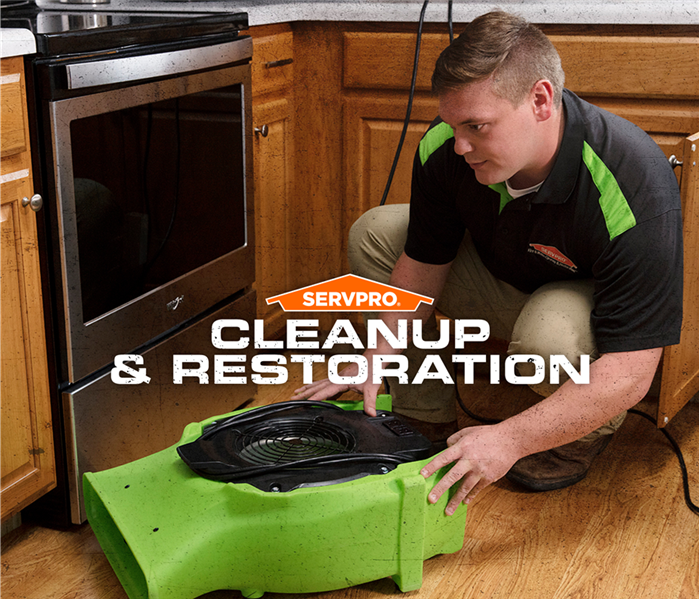 servpro tech placing air mover poster
