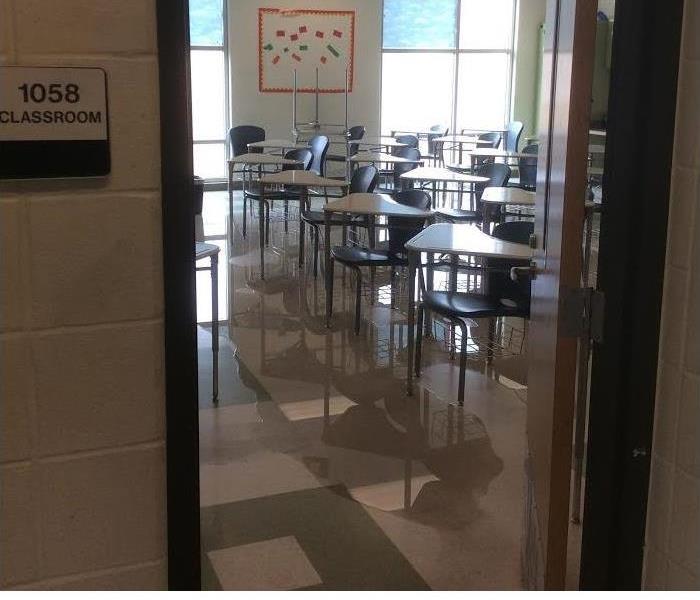 desks sitting in water on tiled floor